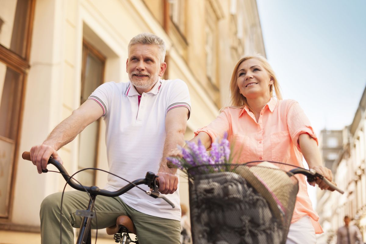 An elderly couple rides bikes together Erectile Dysfunction